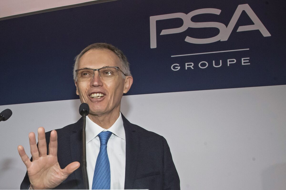 FILE - In this Feb. 26, 2020 file photo, CEO of PSA Groupe Carlos Tavares arrives for the presentation of the company's 2019 full year results in Rueil-Malmaison, west of Paris. Reports of Stellantis CEO Carlos Tavares’ remuneration package of 19.15 million euros during Stellantis’ first year of existence, not counting long-term incentives, caused waves on as Macron and Le Pen campaigned ahead of the April 24 runoff vote. Polls show purchasing power and inflation are a top voter concern. Centrist President Emmanuel Macron, perceived by many voters as being too pro-business, called the pay package “astronomical” and pushed for a Europe-wide effort to set ceilings on “abusive” executive pay. (AP Photo/Michel Euler, File)