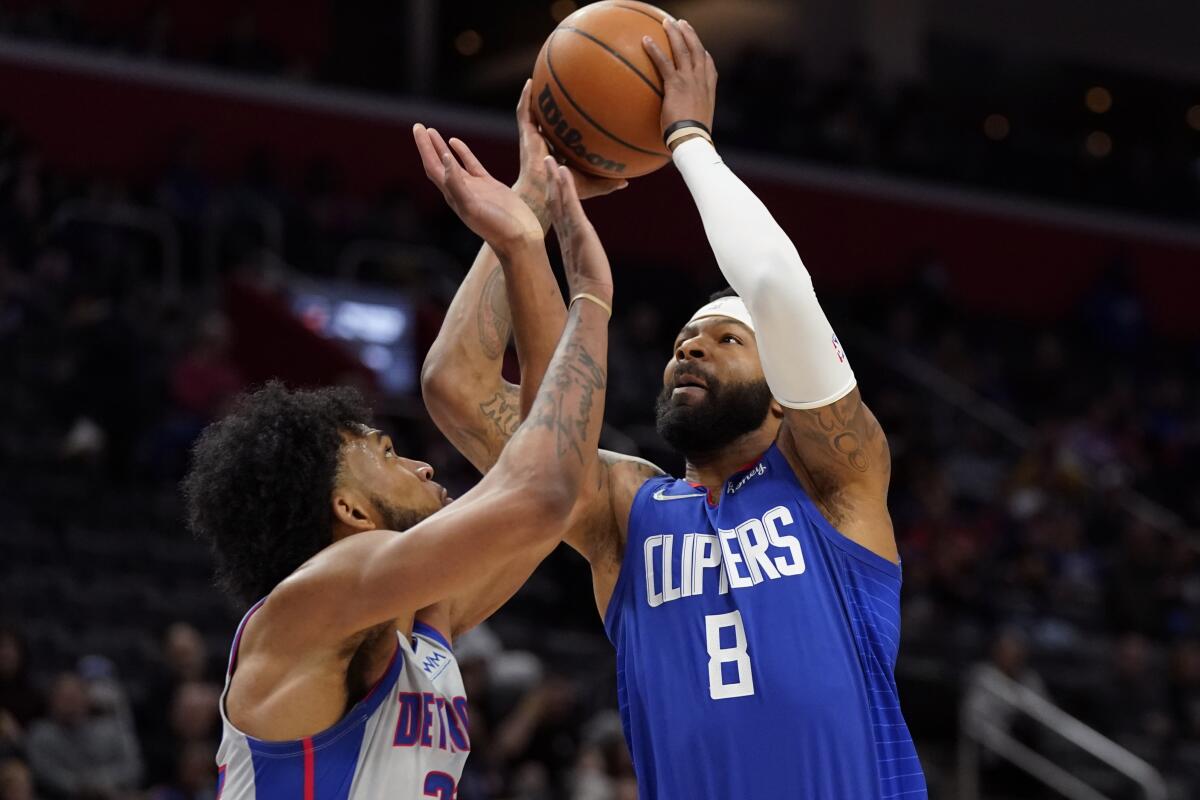 Clippers forward Marcus Morris Sr. is closely defended by Pistons forward Marvin Bagley III.
