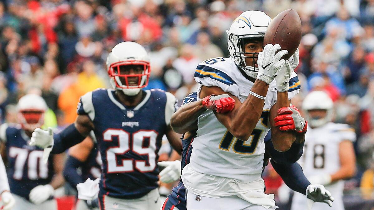 Tyrell Williams of the Chargers catches a pass as he is defended by the Patriots' Jonathan Jones during the third quarter on Sunday.