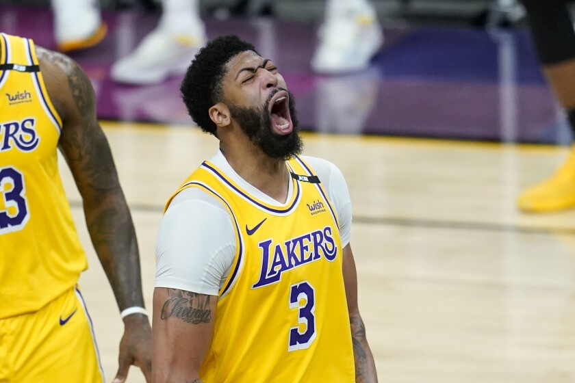 Lakers forward Anthony Davis shouts as he celebrates a defensive stop against the Suns.