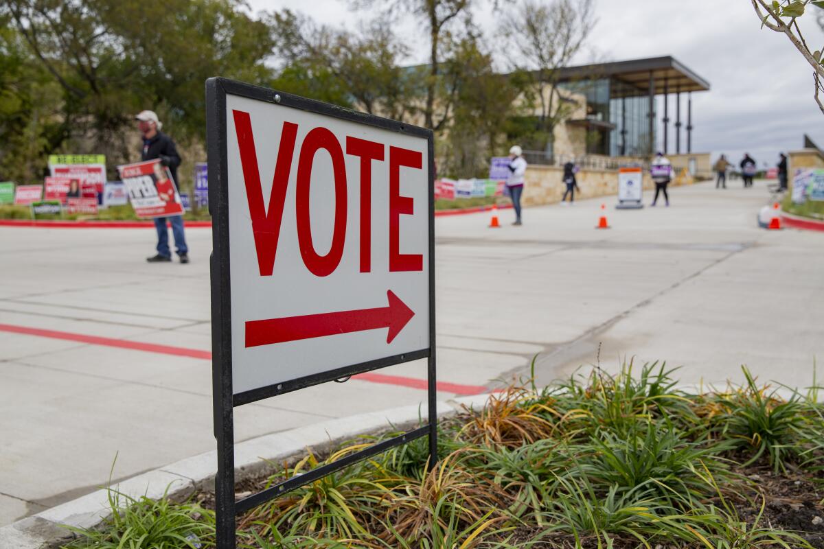 A sign directs people to an early voting location at Collin College in Wylie, Texas, on Thursday. 