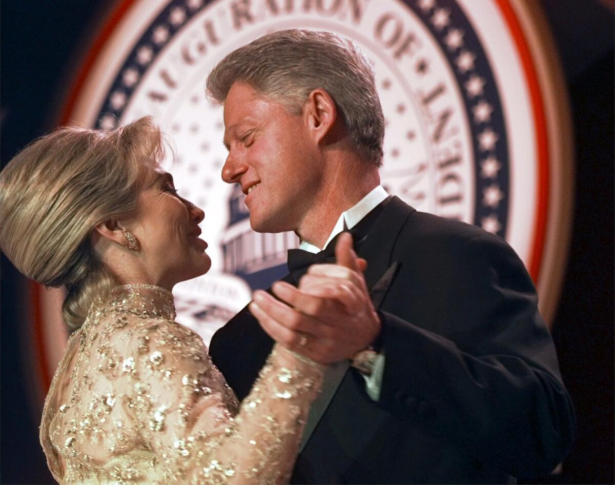 Bill and Hillary Clinton dance in January 1997.