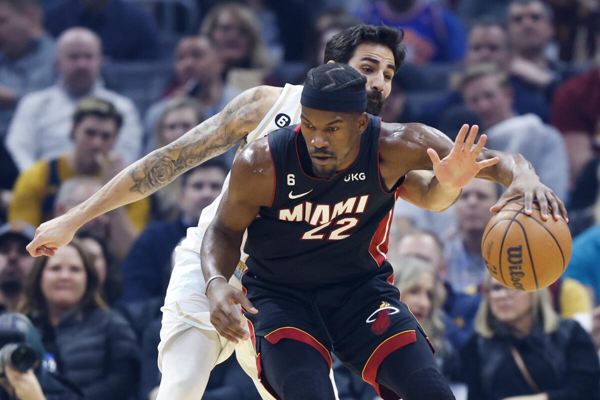 Miami Heat forward Jimmy Butler (22) plays against Cleveland Cavaliers guard Ricky Rubio during the first half of an NBA basketball game, Tuesday, Jan. 31, 2023, in Cleveland. (AP Photo/Ron Schwane)