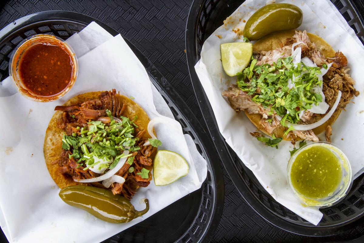 An overhead photo of two tacos with salsa at Carnitas El Momo