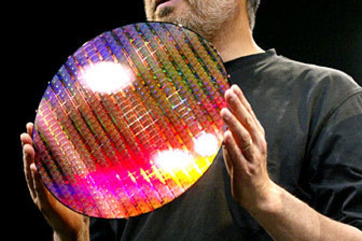 Apple Computer Inc. chief executive Steve Jobs holds the new IBM processor used by the new Apple G5 computer at the Apple Worldwide Developers Conference in San Francisco, Monday, June 23, 2003. Jobs gave the keynote speech that introduced OS X operating system, code-name Panther.