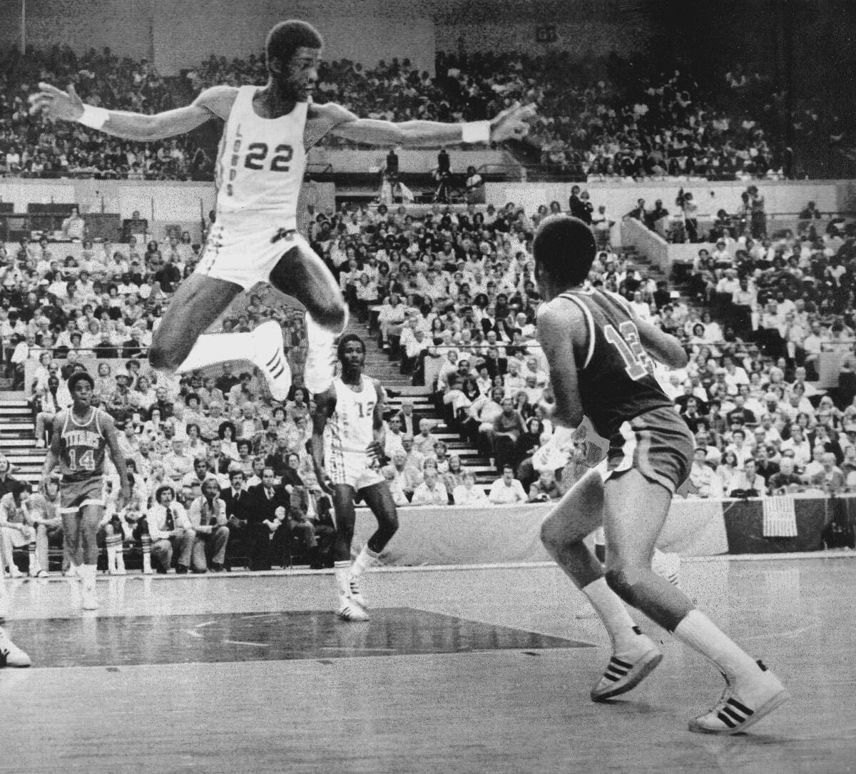 New Mexico's Michael Cooper (22) goes high to prevent a pass by Cal State Fullerton's Keith Anderson (12) in the first half of the NCAA regional basketball playoff.