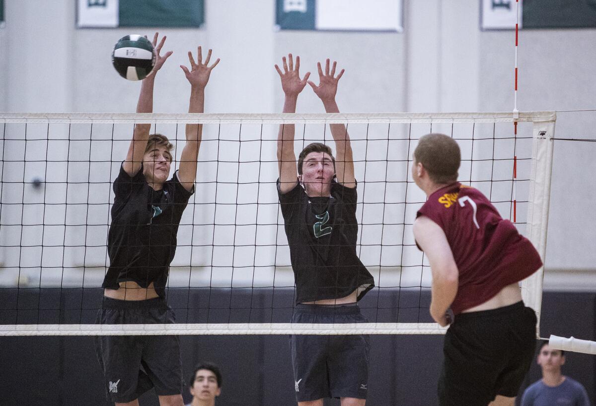 Sage Hill's Carter Bryant, left, and Finn McClintock, center, go up to block a shot by Ocean View's Nathan Capelouto during a nonleague match on Tuesday.