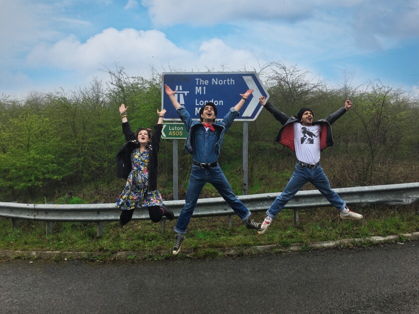 Nell Williams, left, Viveik Kalra and Aaron Phagura leap in the air on a U.K. highway in "Blinded by the Light."