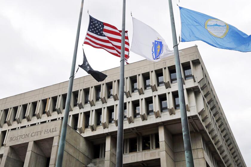 Flags fly at half-staff outside City Hall in Boston, Thursday, Oct. 30, 2014, to mourn the death of former Boston Mayor Thomas Menino. Menino, who was diagnosed with cancer a month after leaving office in 2013, died Thursday, Oct. 30, 2014 in Boston. He was 71. (AP Photo/Elise Amendola)