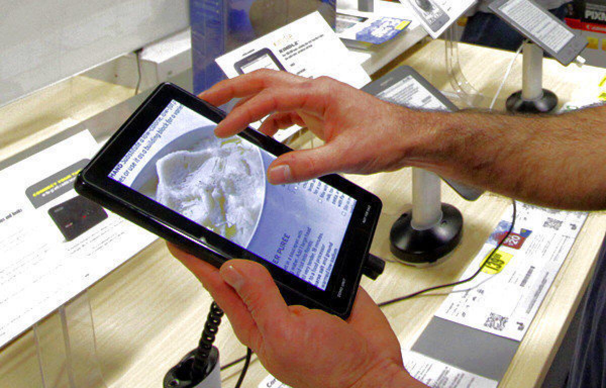 A customer tests out the Kindle Fire tablet.