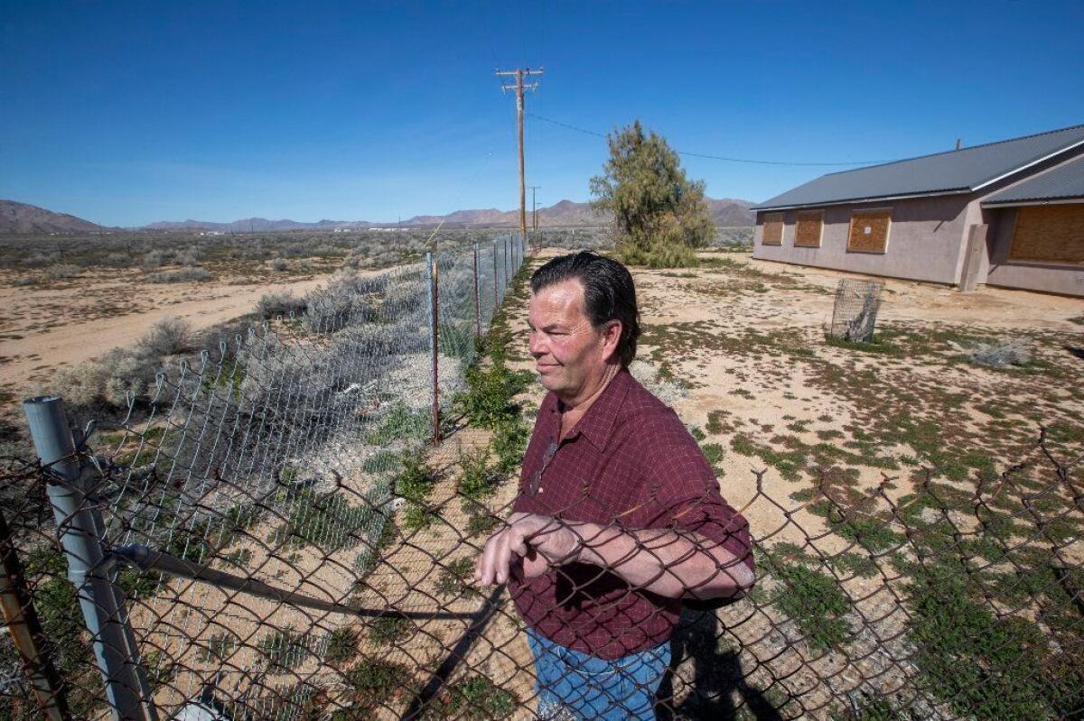 Brian Hammer at his 14-acre property in Lucerne Valley, Calif., on Feb. 25, 2019, where he and his wife still hope to retire. Hammer says the Ord Mountain solar farm, proposed by NextEra Energy Resources, would come within 30 feet of the edge of the property.