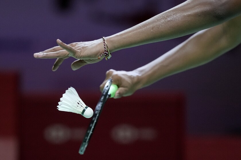 A woman participates in a badminton match
