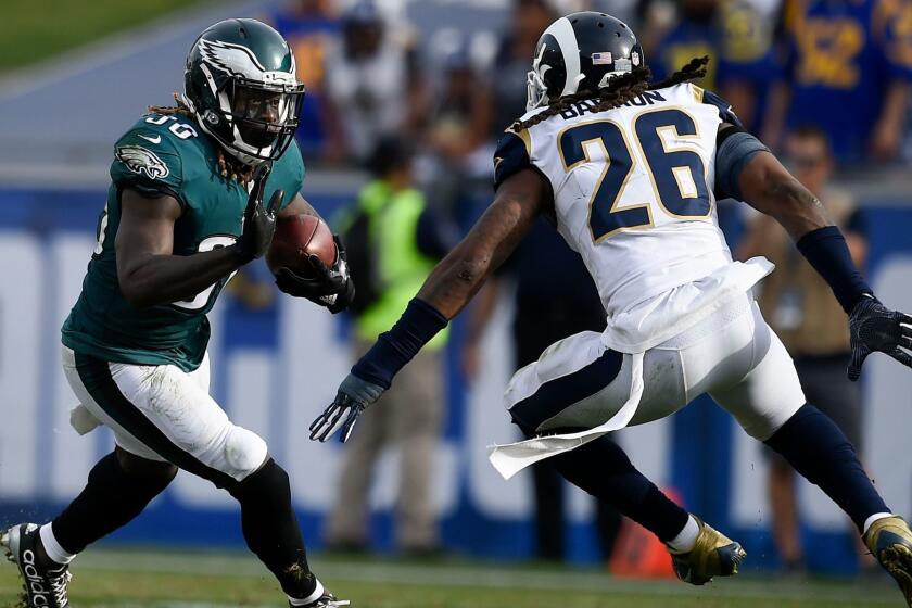 Philadelphia Eagles running back Jay Ajayi, left, runs the ball while Los Angeles Rams linebacker Mark Barron defends during the first half of an NFL football game Sunday, Dec. 10, 2017, in Los Angeles. (AP Photo/Kelvin Kuo)