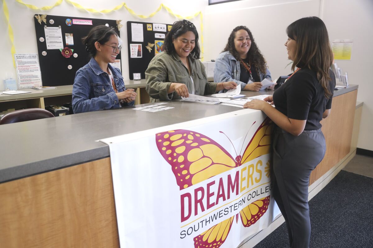Alejandra Garcia, right, project specialist for the Southwestern College Dreamer Center, and student workers for the center, from left, Norma Vizcaino, Samantha Valdivia, and Kelly Alvarez, work on putting together information packets for undocumented students on Tuesday, Nov. 26, 2019 in Chula Vista, California.