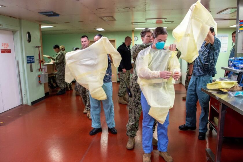 Sailors prepare to admit the first patient aboard the hospital ship USNS Mercy (T-AH 19) March 29. Mercy deployed in support of the nation's COVID-19 response efforts, and will serve as a referral hospital for non-COVID-19 patients currently admitted to shore-based hospitals. This allows shore base hospitals to focus their efforts on COVID-19 cases. One of the Department of Defense's missions is Defense Support of Civil Authorities. DoD is supporting the Federal Emergency Management Agency, the lead federal agency, as well as state, local and public health authorities in helping protect the health and safety of the American people. (U.S. Navy photo by Mass Communication Specialist 2nd Class Abigayle Lutz)