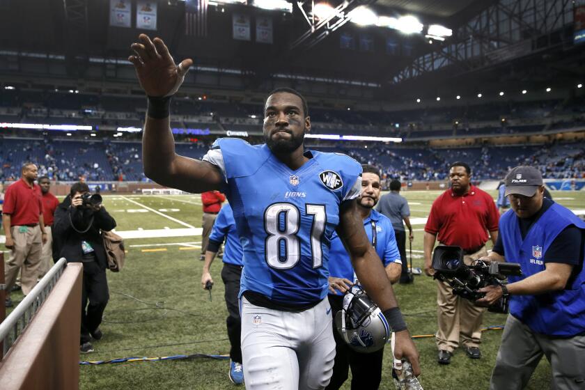 Detroit wide receiver Calvin Johnson waves to fans after a game against Miami on Nov. 9, 2014.