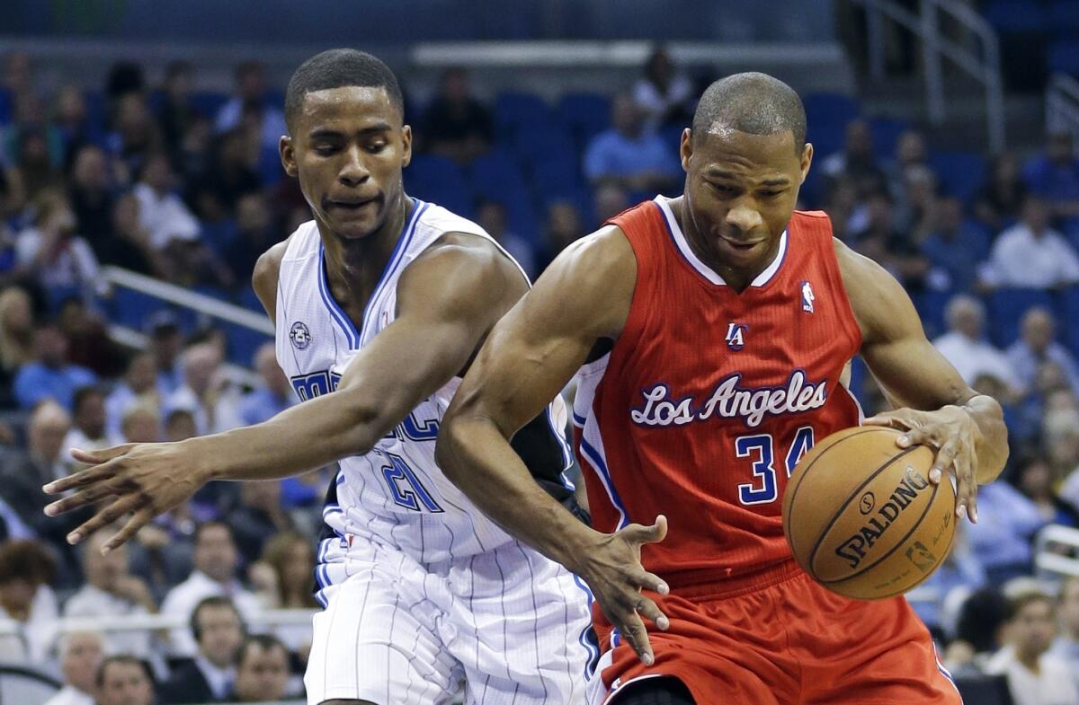 Clippers guard Willie Green, right, tries to drive past Orlando's Maurice Harkless.