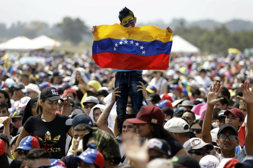 A child holds a Venezuelan flag during the Venezuela Aid Live concert on the Colombian side of Tienditas International Bridge on the outskirts of Cucuta, Colombia.