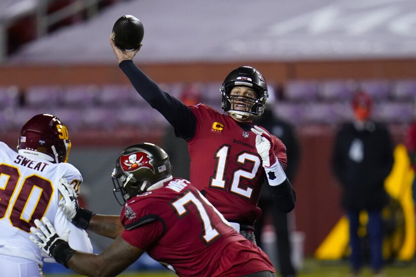 Tampa Bay quarterback Tom Brady throws a touchdown pass to wide receiver Antonio Brown on Jan. 9, 2021.