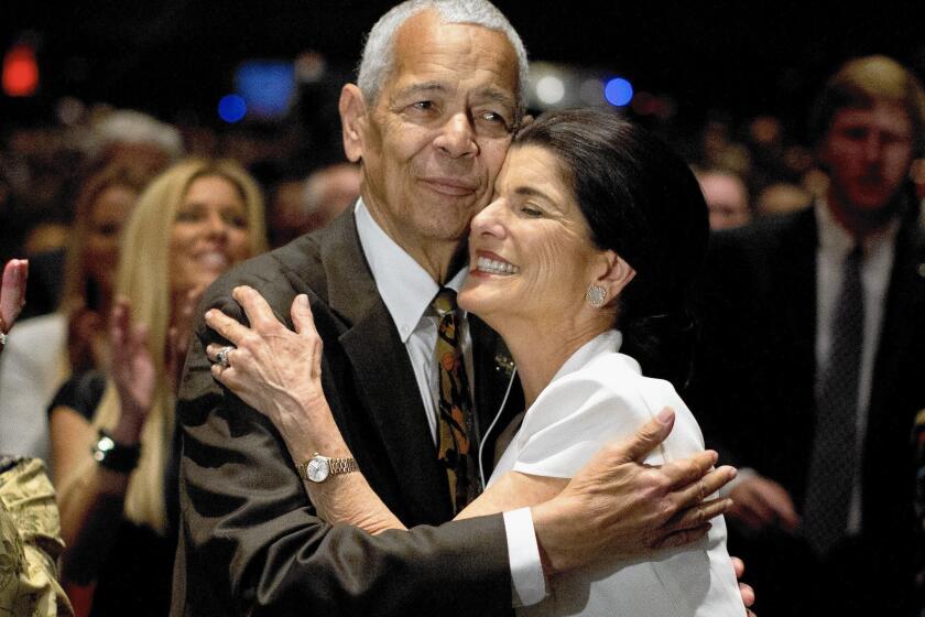 Social activist Julian Bond hugs Luci Baines Johnson, daughter of President Lyndon B. Johnson, during the Civil Rights Summit in April 2014. Bond has died at 75.