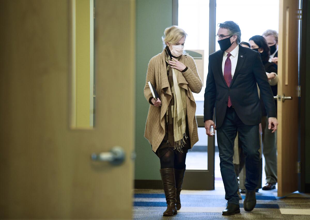Dr. Deborah Birx, White House coronavirus response coordinator, left, walks with North Dakota Gov. Doug Burgum.