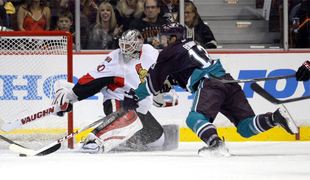 Ducks forward Nick Bonino tries to slip the puck past Ottawa Senators goalie Robin Lehner during the first period of Anaheim's 4-1 win Sunday.