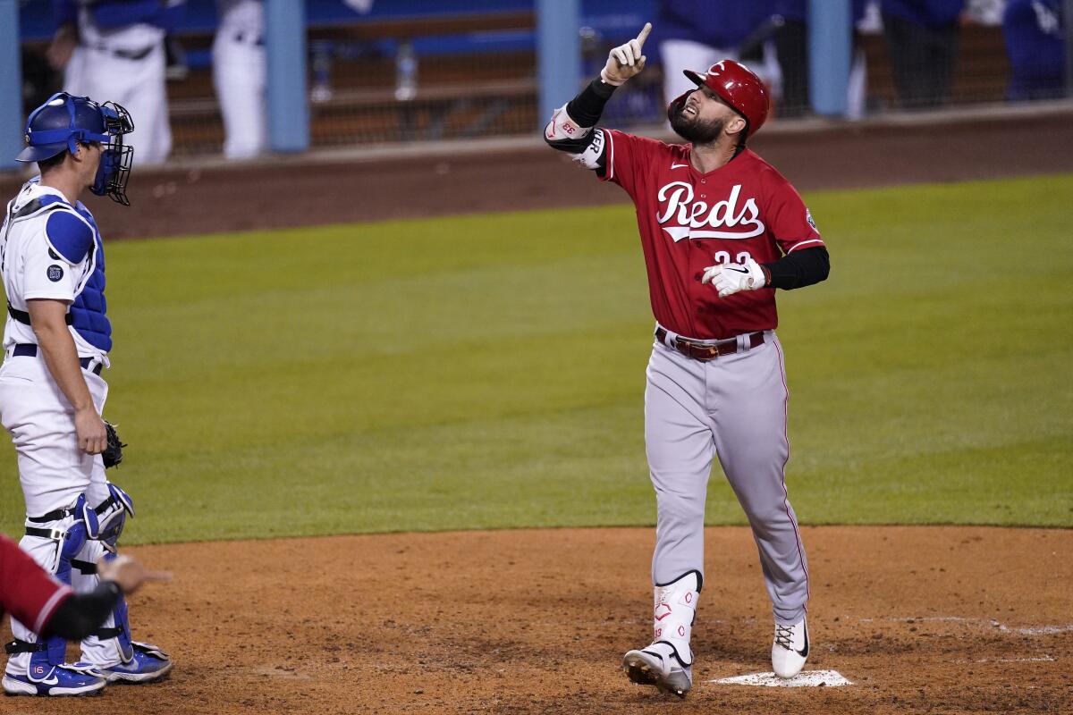 Cincinnati's Jesse Winker points up as he rounds the bases