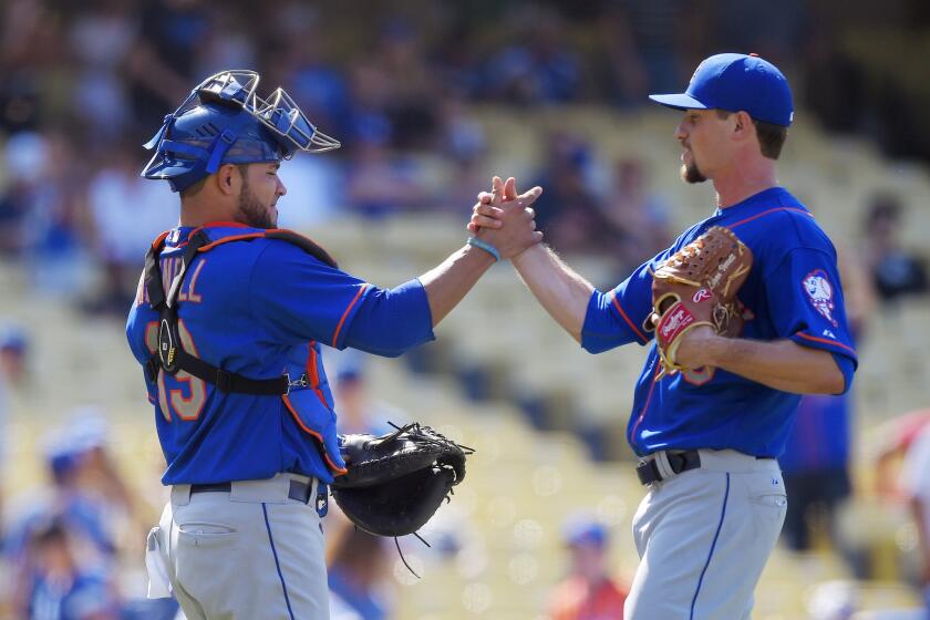 Catcher Johnny Monell and relief pitcher Logan Verrett celebrate the Mets' 8-0 victory over the Dodgers.