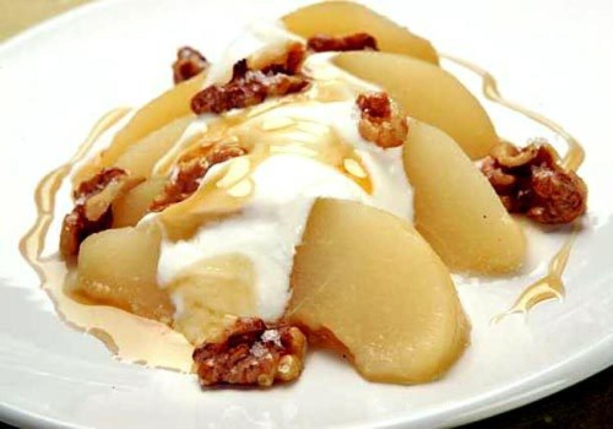 Toasted walnuts top an autumn dessert of honey-poached pear with Greek yogurt. Recipe: Honey-poached pears with Greek yogurt and toasted walnuts