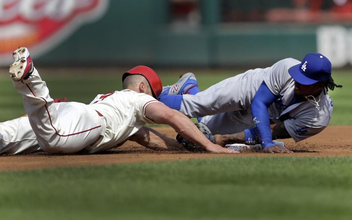 St. Louis' Matt Holliday gets back to second base on a failed pick off attempt in the first inning as shortstop Hanley Ramirez tries to cover the second base.