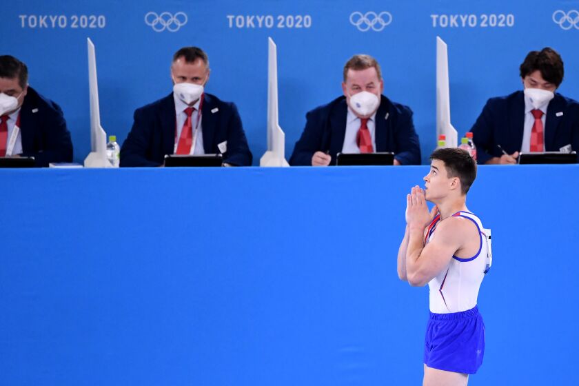 -TOKYO,JAPAN July 26, 2021: ROC's Nikita Nagornyy prays as he walks past the judges before realizing he won the gold medal in the men's team final at the 2020 Tokyo Olympics. (Wally Skalij /Los Angeles Times)