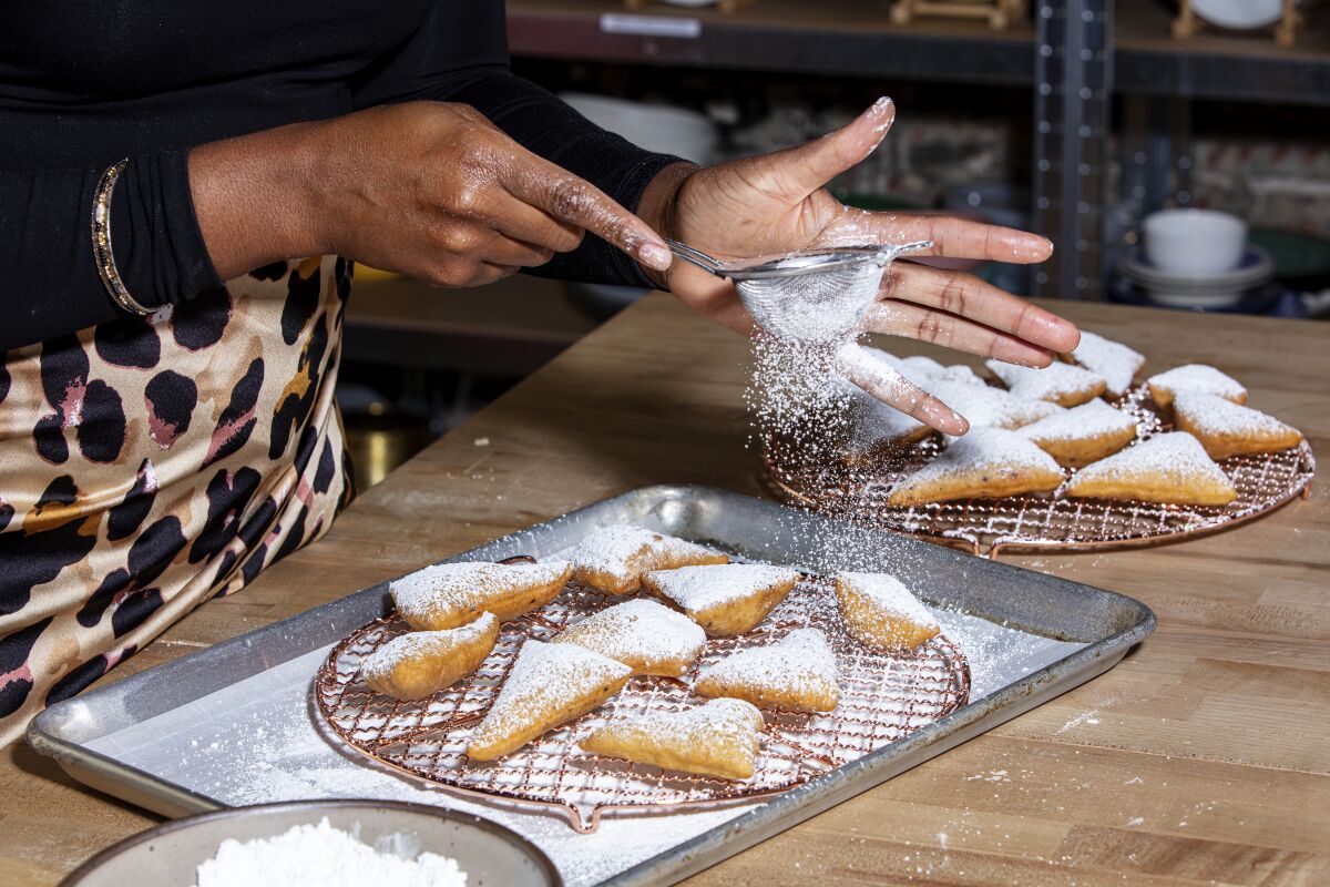 Moju dusts her coconut and cardamom mandazi with powdered sugar for an extra-festive dose of sweetness.