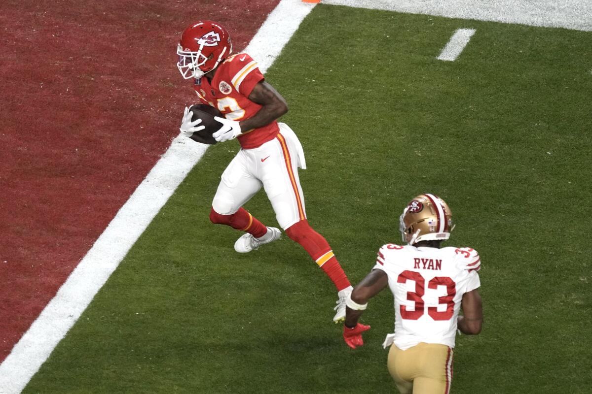 The Chiefs' Mecole Hardman Jr. (12) runs into the end zone for the deciding touchdown in overtime to win Super Bowl LVIII.