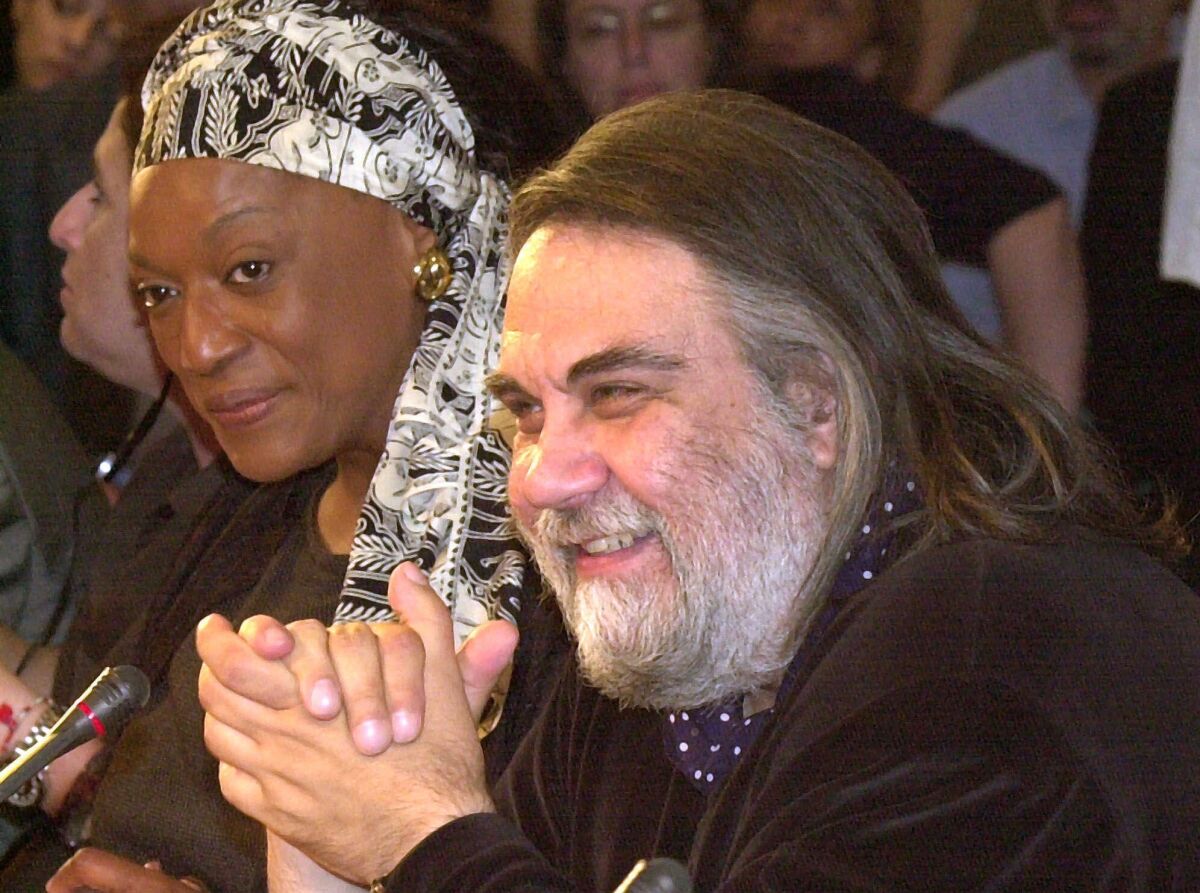FILE - Composer Vangelis Papathanassiou, right, answers a question during a press conference in Athens, June 27, 2001. Vangelis, the Greece-born electronic composer who wrote the Academy Award-winning score for the film "Chariots of Fire" and music for dozens of other movies, documentaries and TV series, has died. He was 79. (AP Photo/Aris Messinis, File)