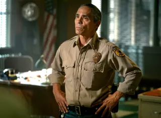 A man in a khaki police uniform.