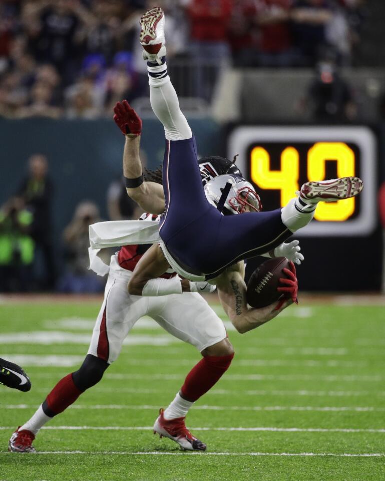 New England Patriots' Julian Edelman is upended by the Atlanta Falcons during the first half of the NFL Super Bowl 51 football game Sunday, Feb. 5, 2017, in Houston. (AP Photo/Jae C. Hong)