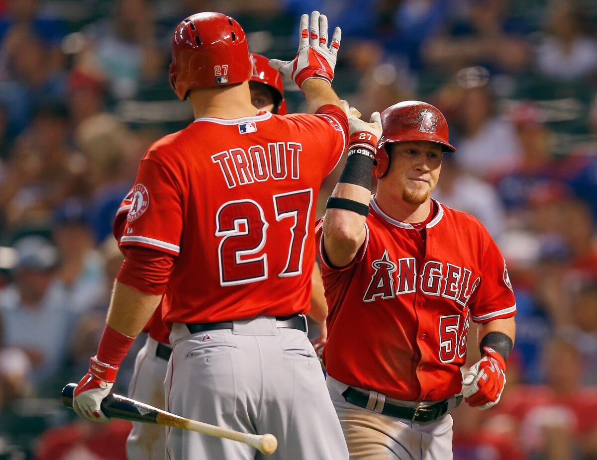 Mike Trout congratulates Kole Calhoun after his three-run home run in the fifth inning of the Angels' 5-4 win Friday over the Texas Rangers.