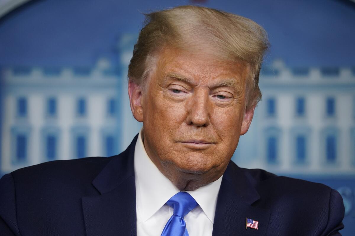 President Trump in front of a White House seal at a news conference