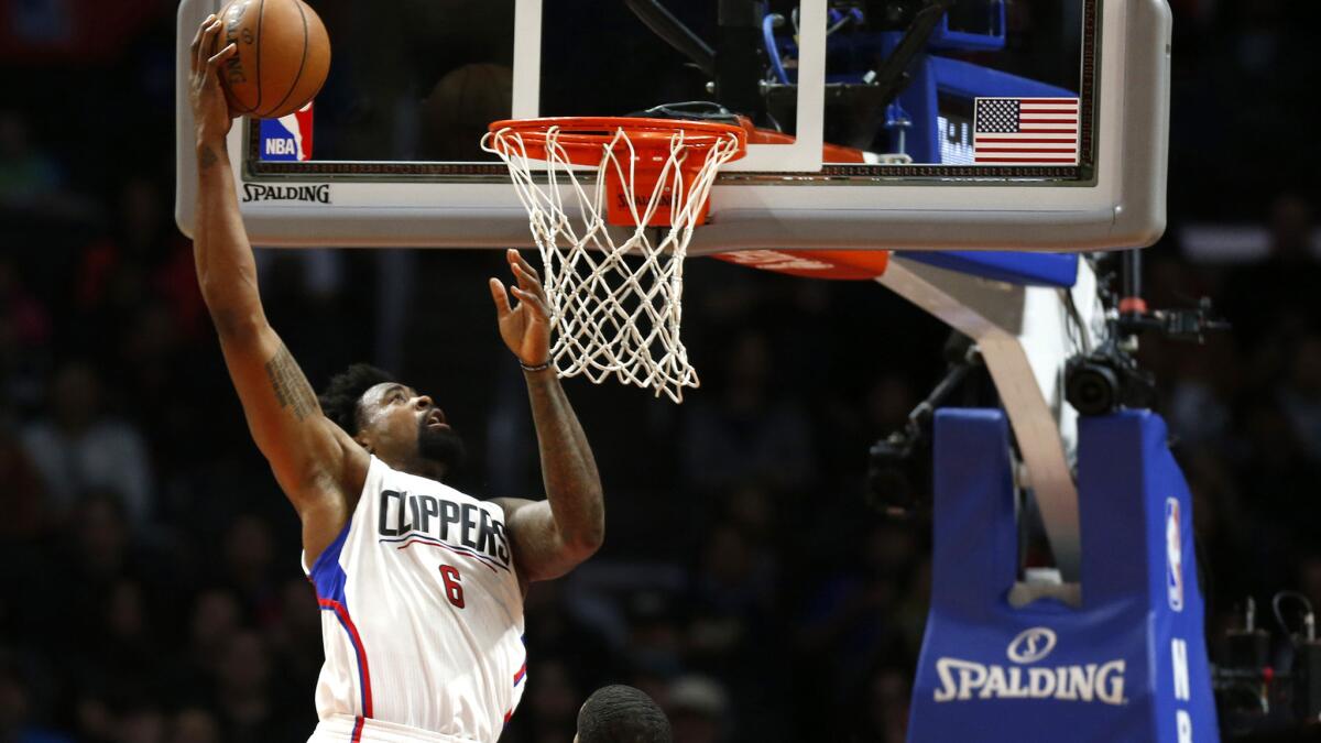 Clippers center DeAndre Jordan (6) dunks over Spurs forward LaMarcus Aldridge during the first half Thursday night at Staples Center.