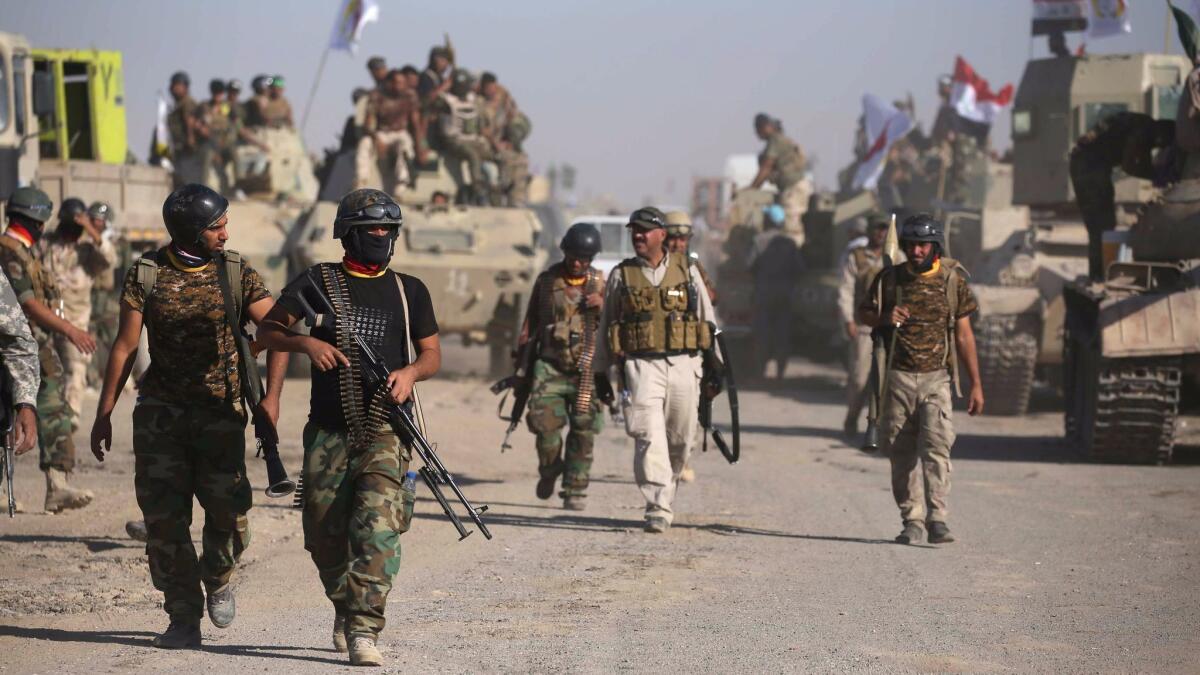 Iraqi government forces supported by fighters from the Abbas Brigade, which fights under the umbrella of the Shiite Popular Mobilization Forces, advance towards the city of Tall Afar, Iraq on Sunday.