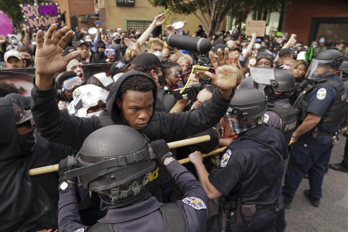 Police and protesters converge during a demonstration, Wednesday, in Louisville, Ky.  