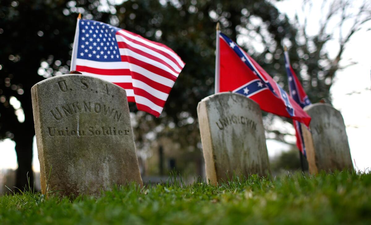 The graves of a Union soldier with Confederate soldiers at Appomattox Court House National Historical Park in Virginia on April 7.