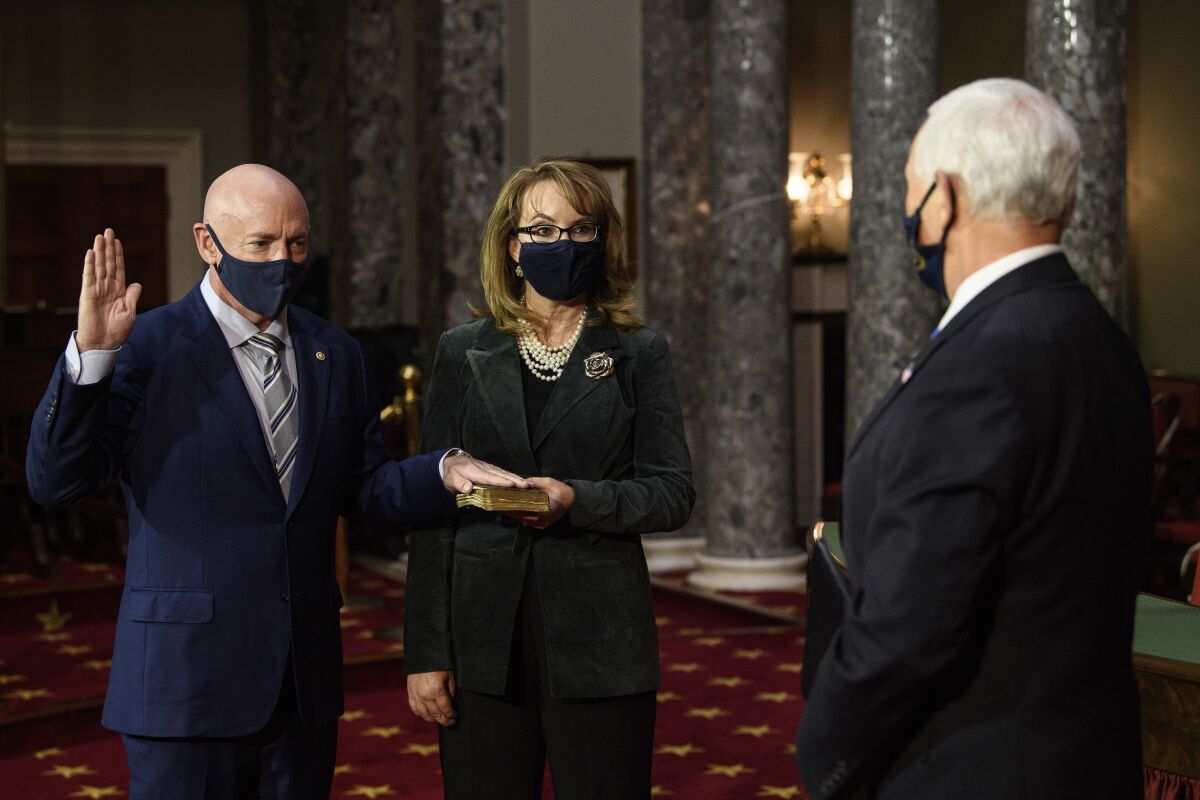 Sen. Mark Kelly in a reenactment of his swearing-in with wife Gabrielle Giffords and Vice President Mike Pence.