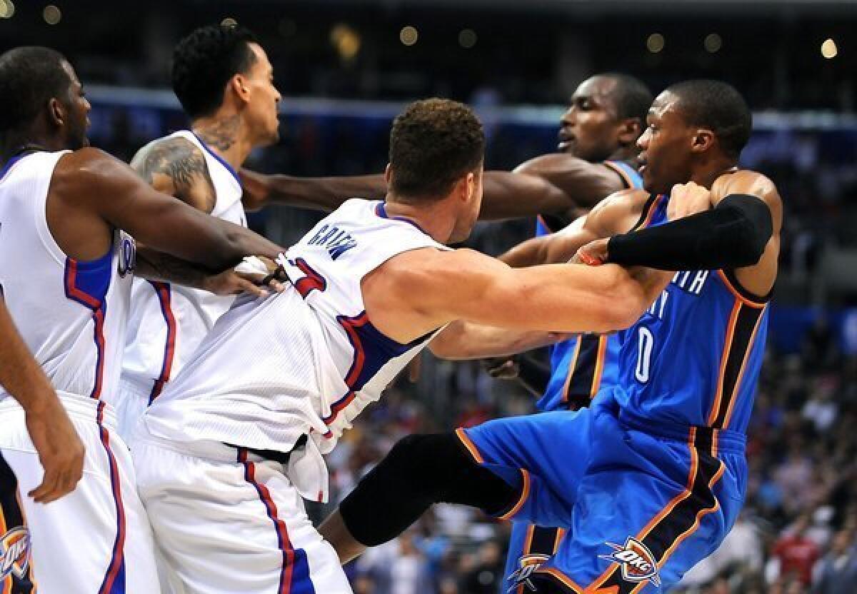 Blake Griffin pushes Russell Westbrook as Matt Barnes and Serge Ibaka tangle just before the end of the first half Wednesday at Staples Center.