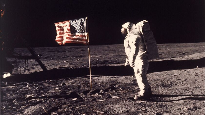 In this image provided by NASA, astronaut Buzz Aldrin poses for a photograph beside the U.S. flag deployed on the moon during the Apollo 11 mission on July 20, 1969.