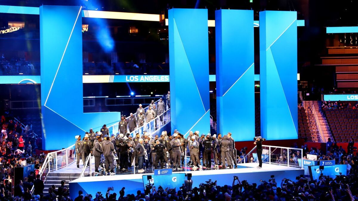 The Rams walk out on stage during Super Bowl LIII Opening Night at State Farm Arena.