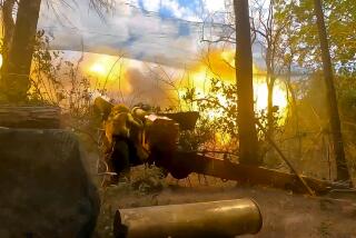 In this photo taken from video released by Russian Defense Ministry Press Service on Wednesday, July 3, 2024, Russian soldiers fire from their 152-mm ?Giatsint-B? howitzer from their position at Ukrainian troops at an undisclosed location in Ukraine. (Russian Defense Ministry Press Service via AP)