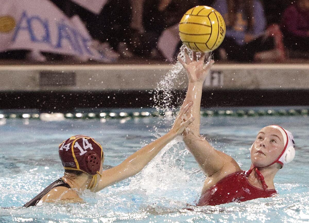Burroughs' Charlotte Jennings' arm is hit by Arcadia's Delany Prater as she passes in the Pacific League girls' water polo championship at Arcadia High School on Thursday, February 6, 2020. Arcadia won the match in the second overtime.