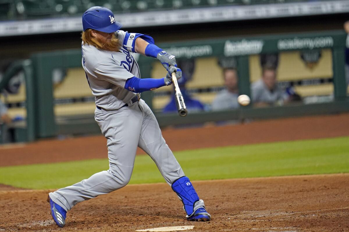 Dodgers third baseman Justin Turner hits a run-scoring single against the Houston Astros during the fifth inning.