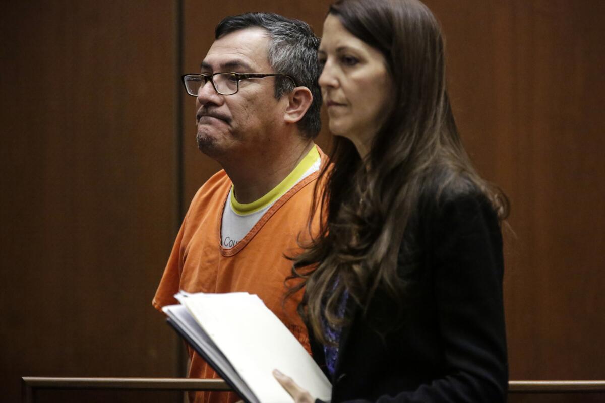 Erwin Mena appeared in a downtown Los Angeles courtroom on Wednesday with his attorney, Denise Daniels. He was sentenced to one year in county jail and one year of supervised release after pleading guilty to one count of grand theft.